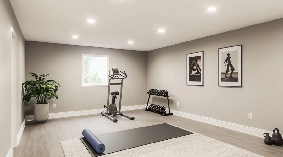 Ett modernt och minimalistiskt hemmagym med träningsmaskin, hantlar och yogamatta.